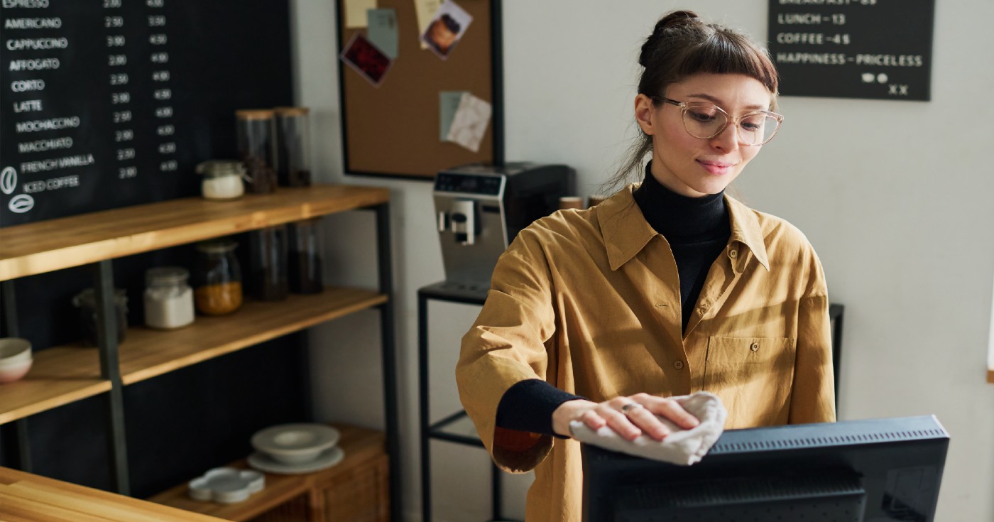 Woman cleaning computer