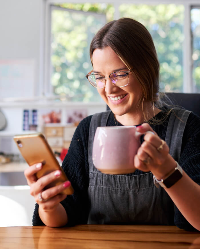 woman with coffee and phone