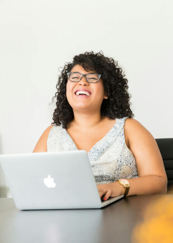 woman smiling on computer